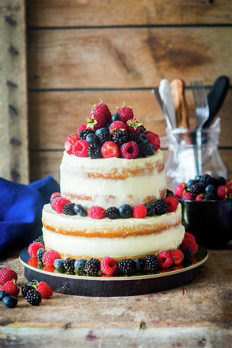 A Two Tier Semi Naked Cake With Vanilla Cream And Fresh Berries Photograph By Irina Meliukh