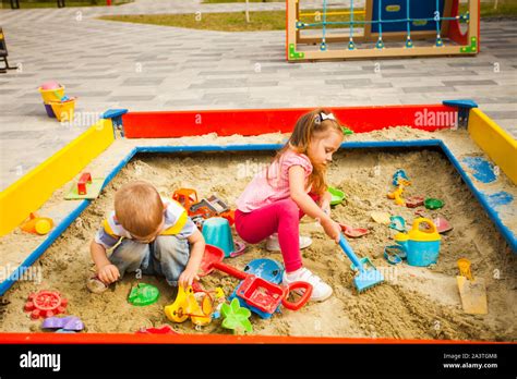 Two Children Playing In Sandbox In Sunny Day Stock Photo Alamy