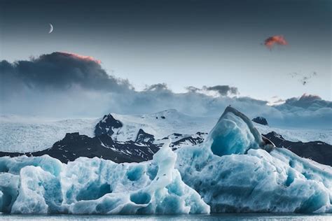 Premium Photo Scenery Of Blue Iceberg Floating And The Moon In