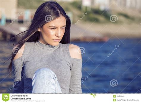 lonely girl sitting  chir wood   riverside stock image image