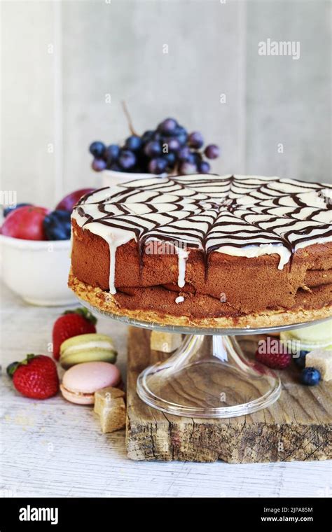 Halloween Chocolate Spider Web Cake And Various Fruits Around Party