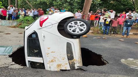 Car Submerges In Sinkhole As Portion Of Road Caves In After Rains In