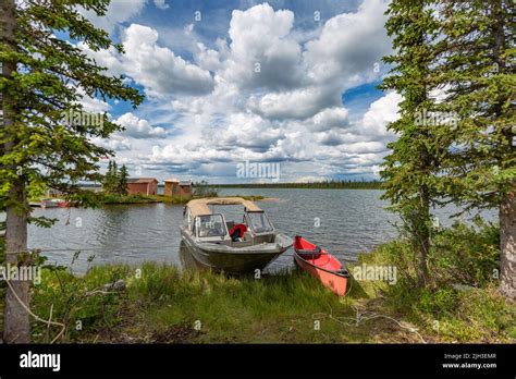 Boat And Canoe Parked At Cabin Along Great Bear Lake In The Summer Near The Northern Indigenous