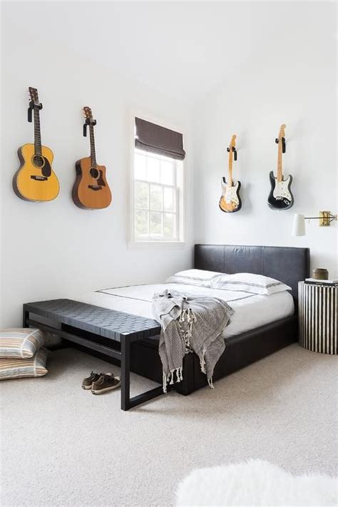 Boys Bedroom Featuring Guitars Mounted As Art Over The A Leather Bed