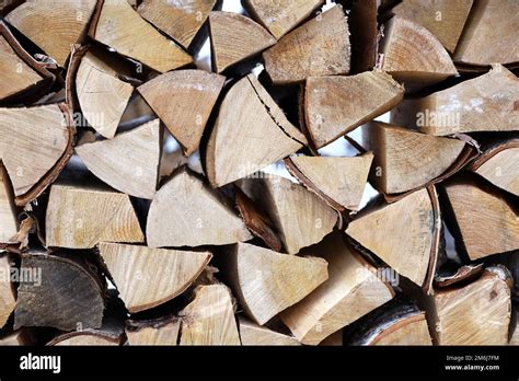 Chopped Firewood In The Woodpile Stack Of Wood On Winter Street Stock