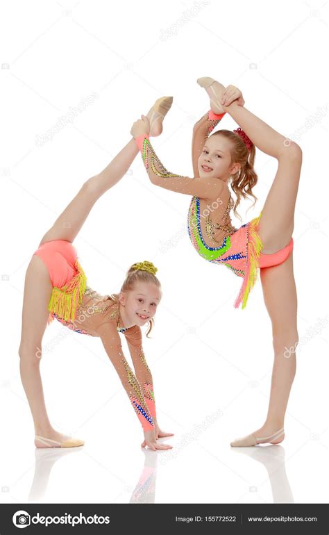 Two girls gymnast sitting on splits. — Stock Photo © lotosfoto1 #155772522