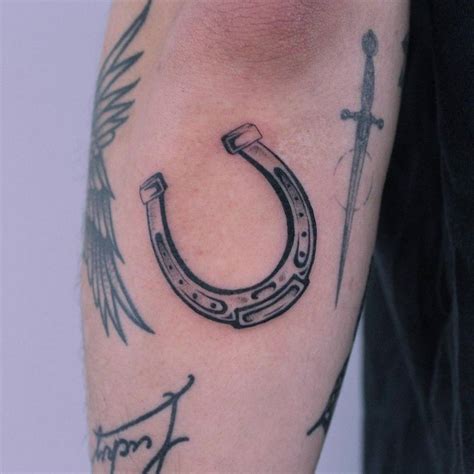 Horseshoe tattoo on the forearm.