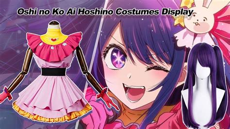 an anime cosplay with purple hair and pink eyes wearing a dress that says oshiko ko ai hasho ...