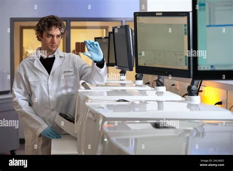 Dna Sequencers Technician Next To A Row Of Gs Flx Sequencing Machines