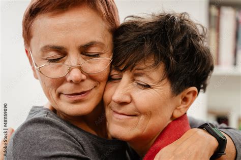 Mature Lesbian Couple Hugging And Smiling At Home Stock Photo Adobe Stock