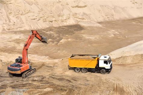 Excavator Load The Sand To The Heavy Dump Truck In The Open Pit Heavy Machinery Working In The