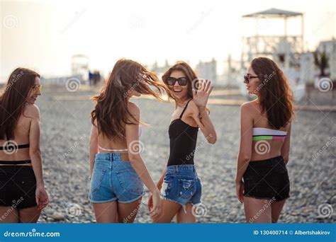 Women Strolling Along Coastline Female Friends Walking Together On