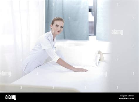 Smiling Nurse Making Hospital Bed Stock Photo Alamy