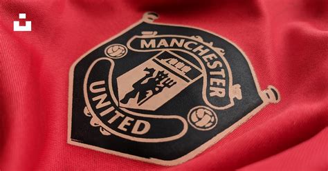 A manchester united emblem on a red shirt photo – Free Symbol Image on ...