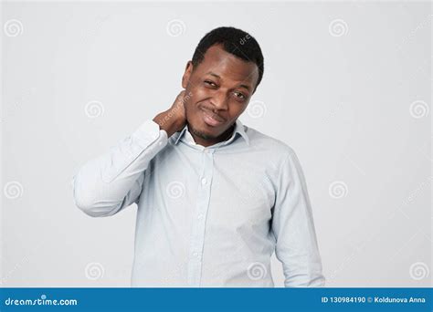 Confused African Man Scratching Head While Looking At Camera And