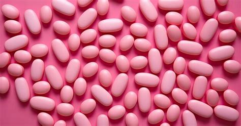 Premium AI Image | dozens of pink pills on a surface in the style of ...