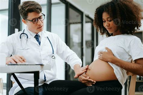 Pregnant African Woman Has Appointment With Doctor At Clinic Male