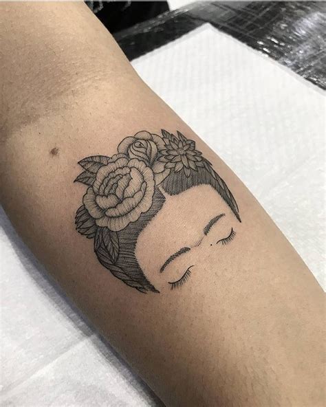 A Woman S Arm With A Tattoo On It That Has Flowers In The Shape Of A Head