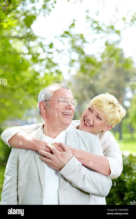 Portrait Of Happy Mature Woman Hugging Her Husband Outside Stock Photo Alamy