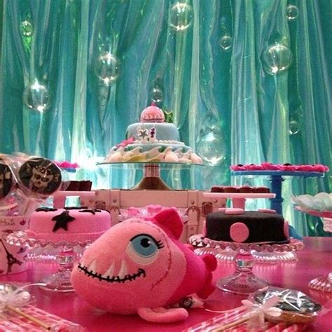 A Pink Table Topped With Lots Of Cakes And Desserts