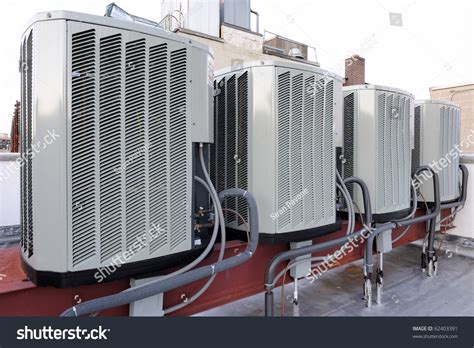 Stock Photo A Row Of Air Conditioning Units On A Rooftop 62403391