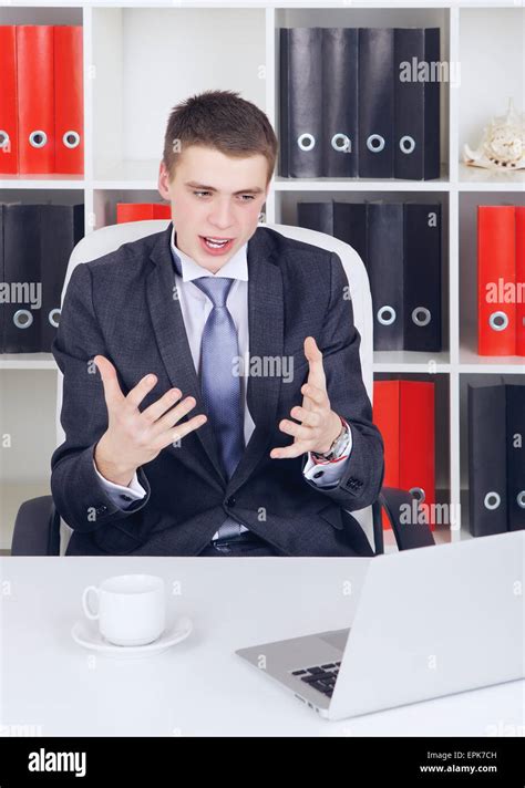 happy young businessman with laptop in his office Stock Photo - Alamy