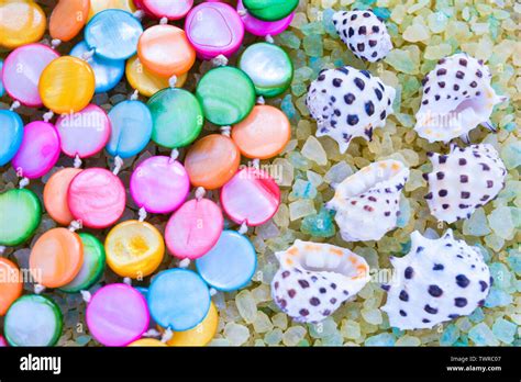 Sea Shells And Colorful Pearl Beads On Crystals Of Aromatic Bath Sea