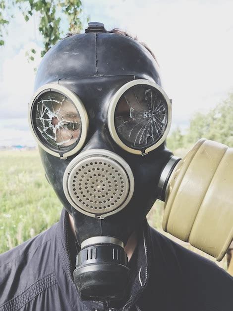 Premium Photo Close Up Portrait Of Man Wearing Gas Mask Against Sky