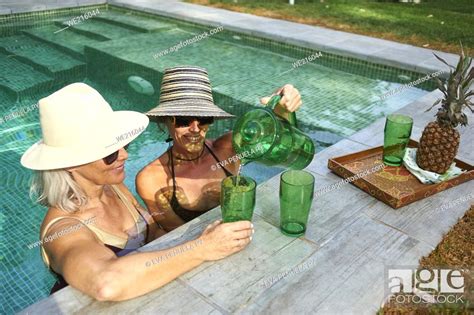 Two Mature Friends Enjoying An Afternoon At The Pool Stock Photo Picture And Royalty Free