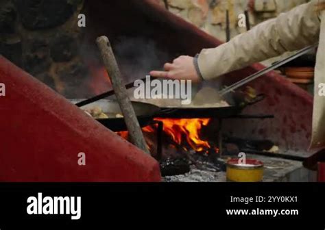 Chefs In Casual Clothes Mix Ingredients Cooking Paella Open Fire Heats