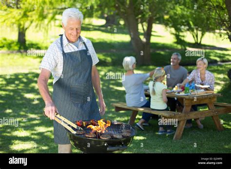 Happy Grandfather Doing Barbecue Stock Photo Alamy