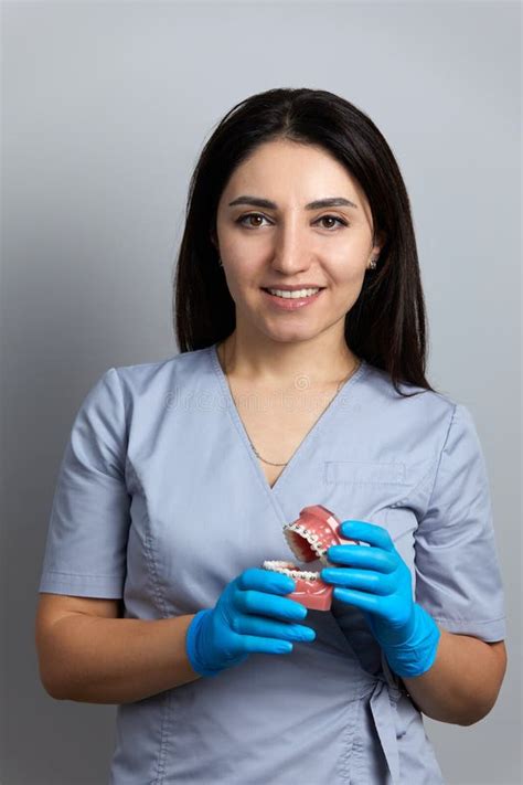 Doctor Orthodontist Showing Model Of Human Jaw With Wire Braces