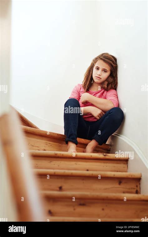 I Feel So Alone Here A Little Girl Looking Sad While Sitting On The