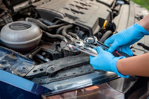 Car Mechanic Repairman Hands Repairing Car Engine Of Car Workshop With