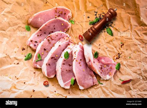 Fresh Raw Pork Chops On A Cutting Board Arrangement On The Wrapping