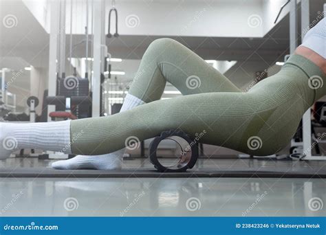 Female Trainer Massages The Muscles Of The Hips And Legs In Gym Self