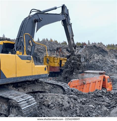 Modern Excavator Loading Soil Into Truck Stock Photo 2256248849