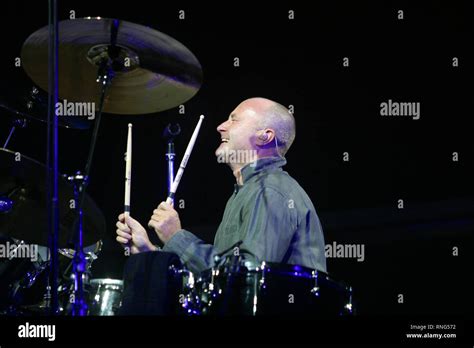 Musician Phil Collins is shown performing on stage during a "live ...