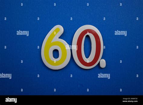 The Number 60 Placed On A Blue Background Photographed From Above