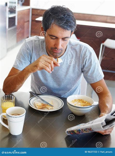 Mature Man Having Breakfast And Reading Newspaper Stock Image Image
