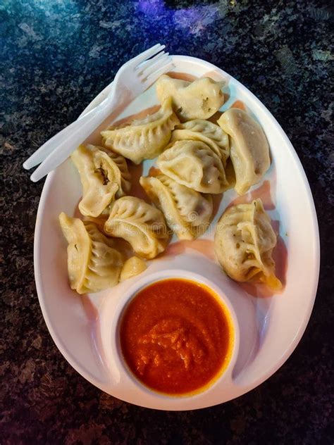 Chicken Momo Served with Sauce in a White Plate. Top View Stock Photo ...