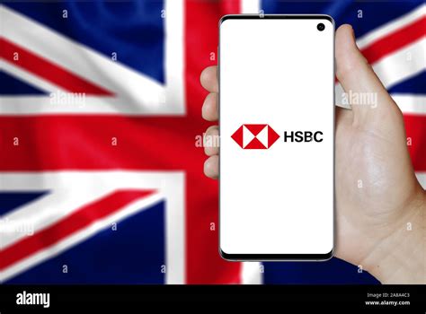 Logo of public company HSBC displayed on a smartphone. Flag of UK ...