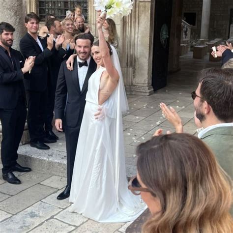 The Bride And Groom Are Waving To Their Guests