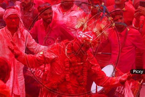 Image Of A Man Daubed In Colour Dances As He Takes Part In A Colourful