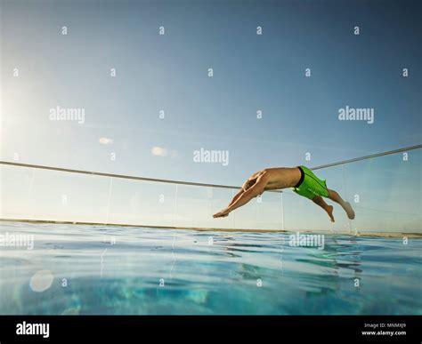 Man Jumping Into Swimming Pool Stock Photo Alamy