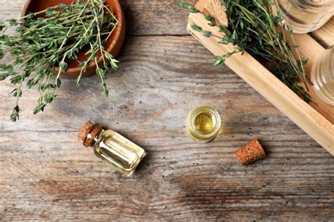 Flat Lay Composition With Essential Oil In Glass Bottles And Thyme