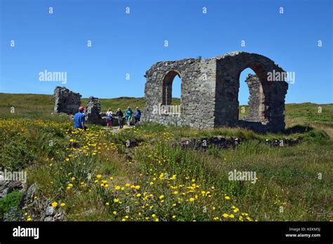 The ruined Church of St. Dwynwen on Llanddwyn Island, Anglesey, Wales Stock Photo - Alamy