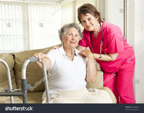 Friendly Nurse Cares For An Elderly Woman In A Nursing Home Stock