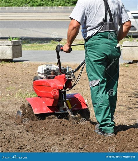 Gardener Works with a Tiller Machinery Stock Photo - Image of planting