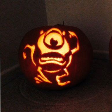 Two Pumpkins Carved To Look Like Monsters With Faces On Them One Is